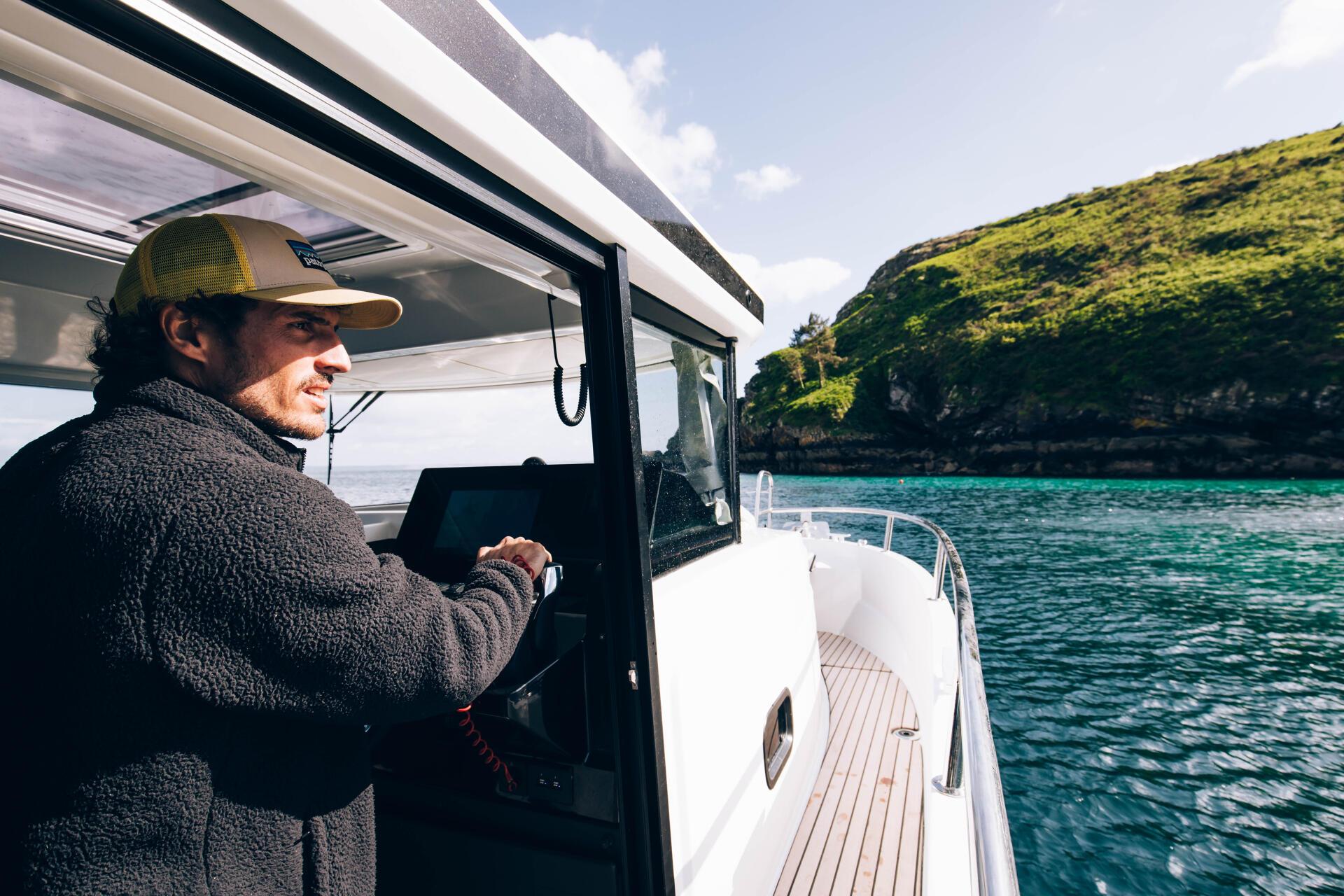 a man driving a boat Merry fisher 895 S2