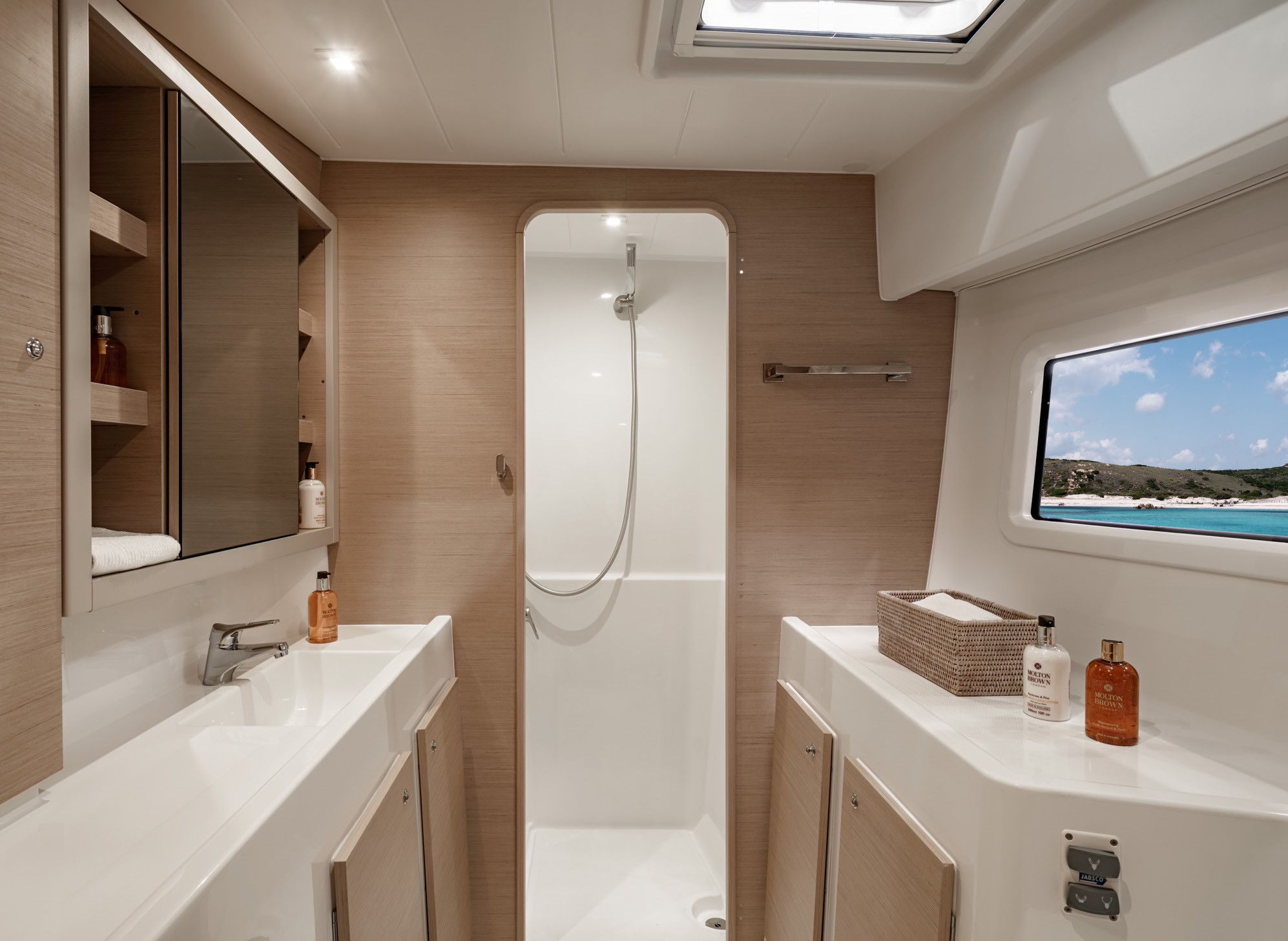 a bathroom with a shower and sink on boat