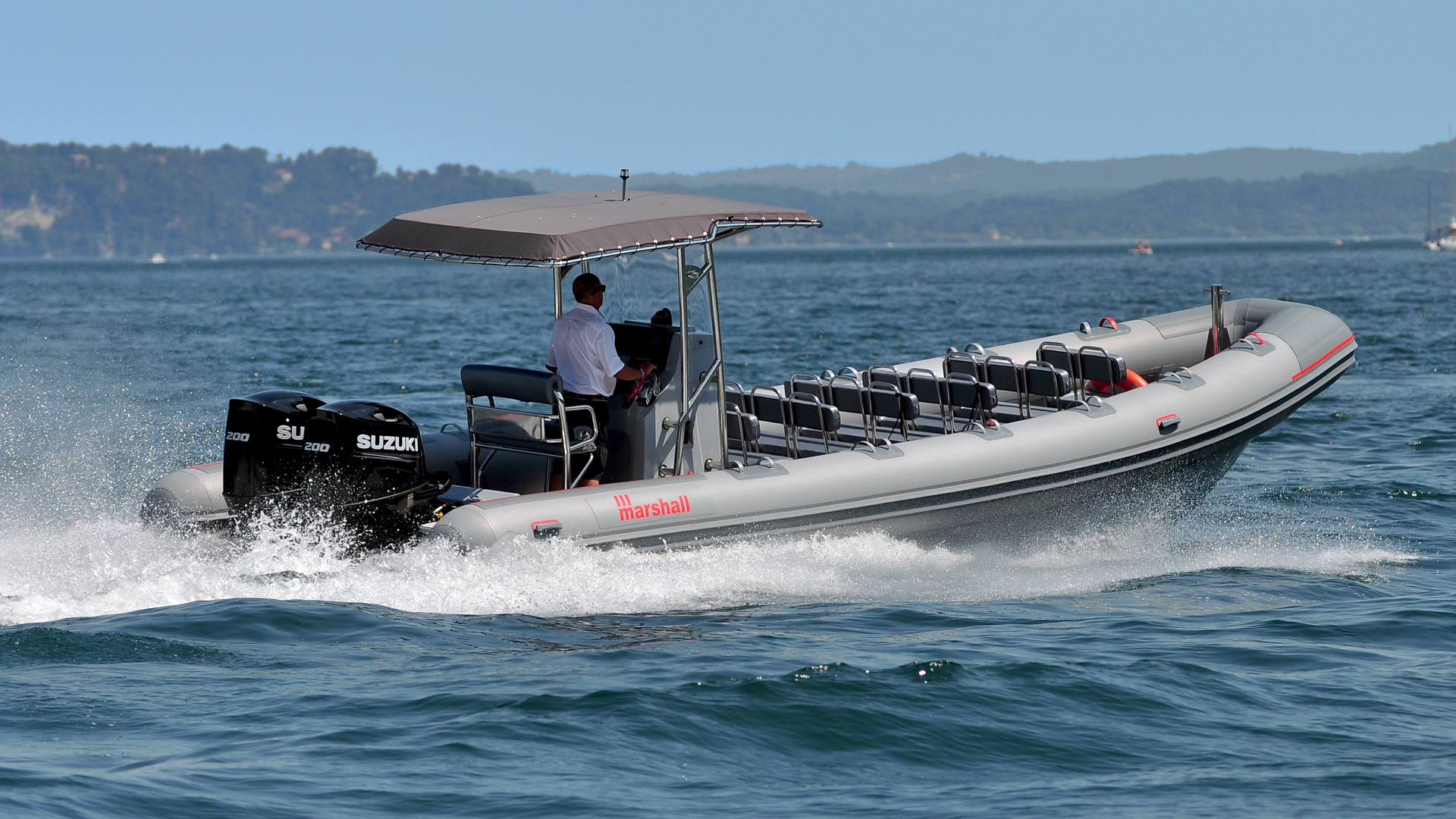 a man driving a boat on the water